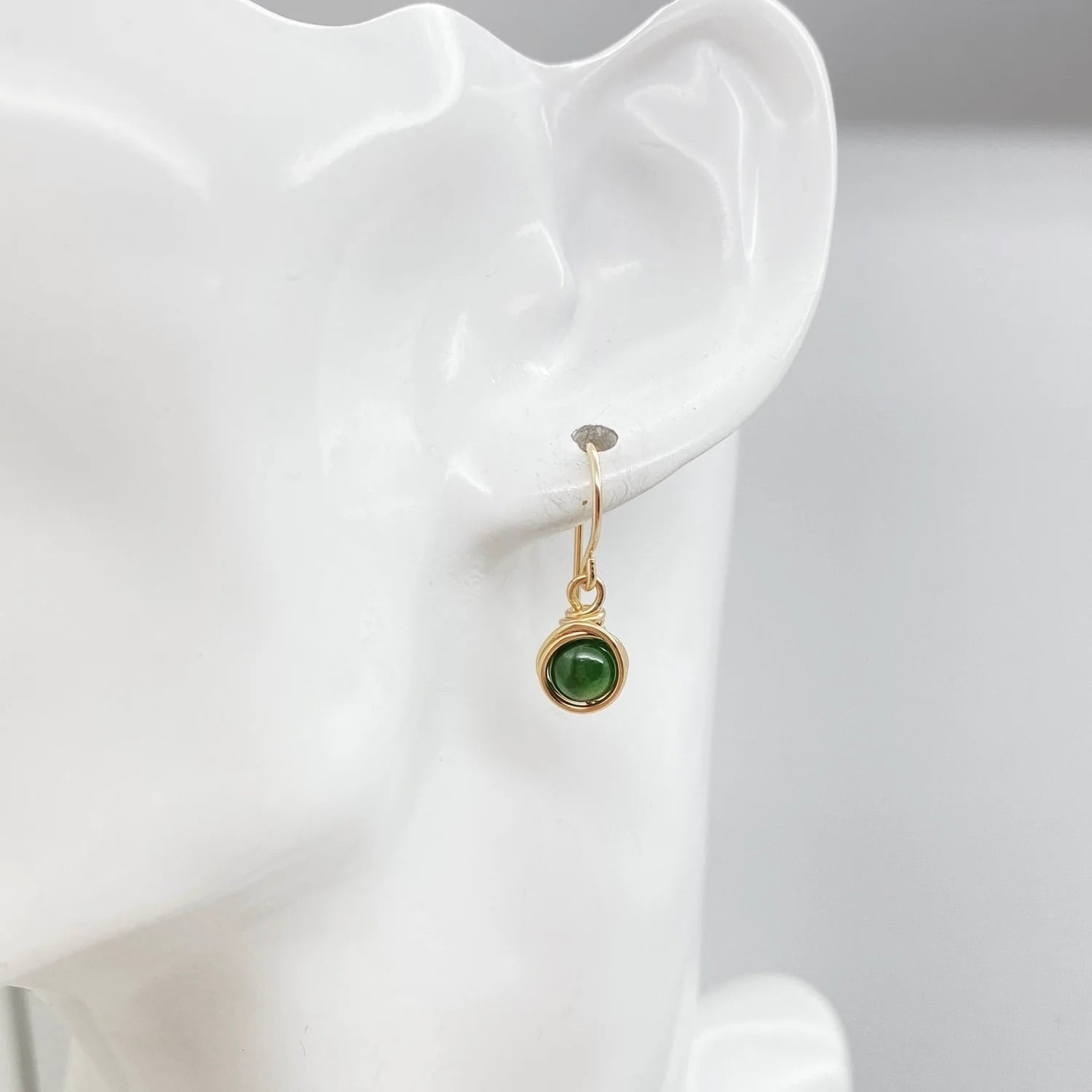 Oorbellen met nefriet jade van vooraanzicht aan mannequin hoofd