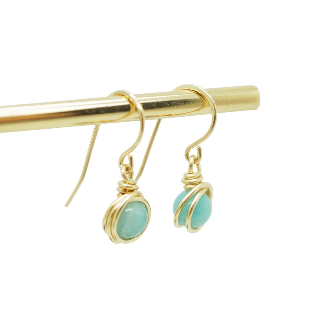 Close-up van 14k gold filled wire wrap oorbellen met Amazoniet steen, handgemaakt.
