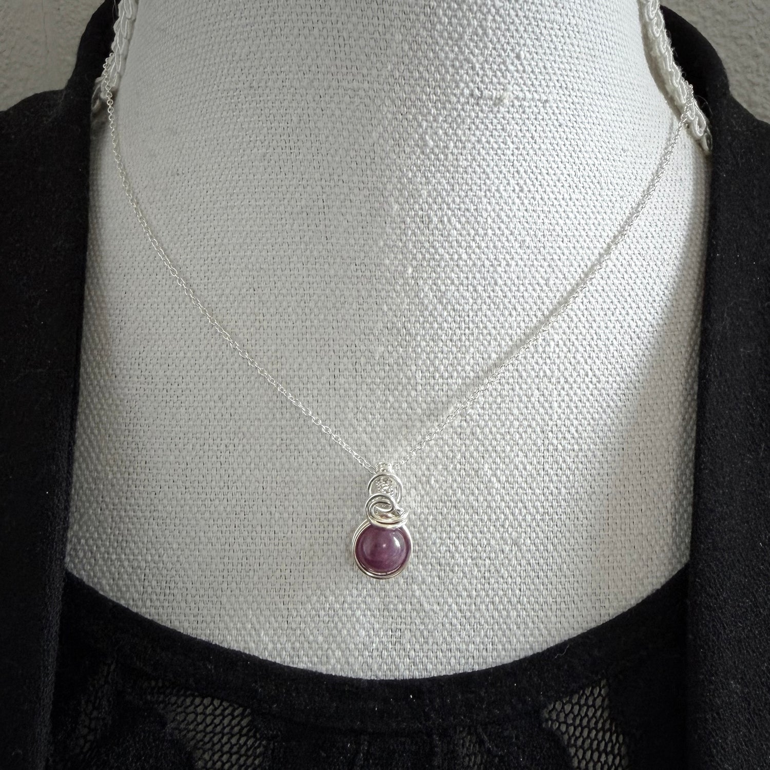 Sierlijke sterling zilveren wire wrap hanger met robijn